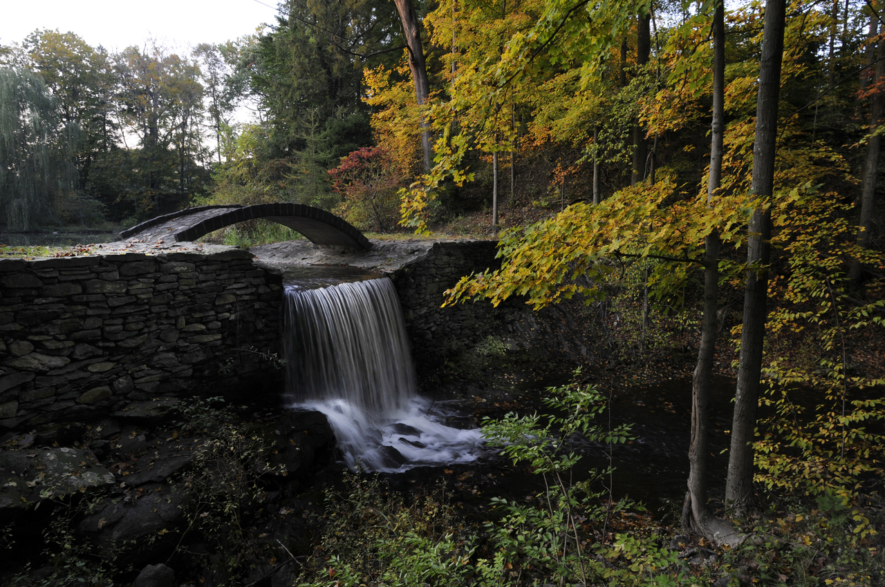 Waterfall and stone bridge at Buttermilk Falls Inn & Spa